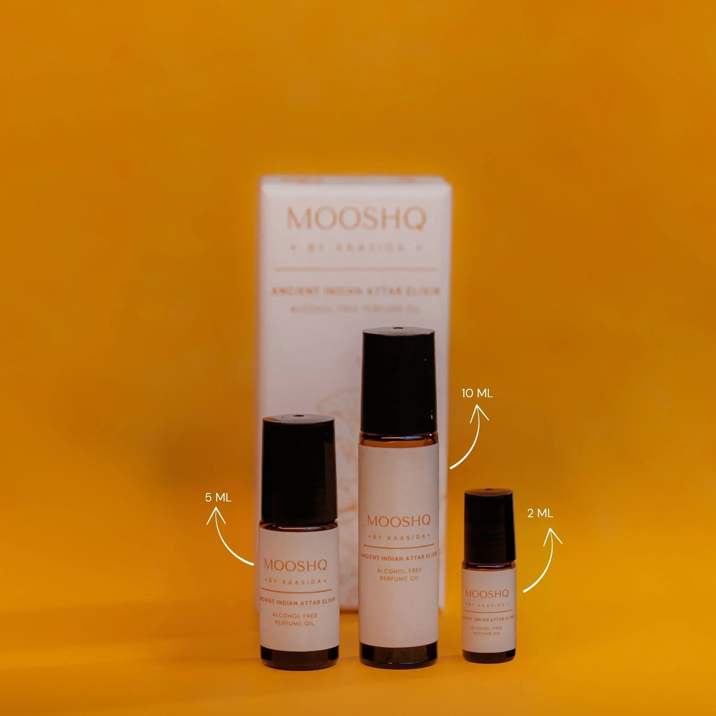 MOOSHQ perfume oil bottles in 10, 5 and 2 ML sizes comparison on an orange background