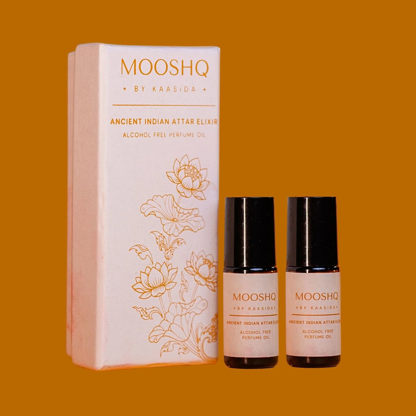 Two bottles of MOOSHQ alcohol-free perfume oil bottles by Kaasida on an orange background