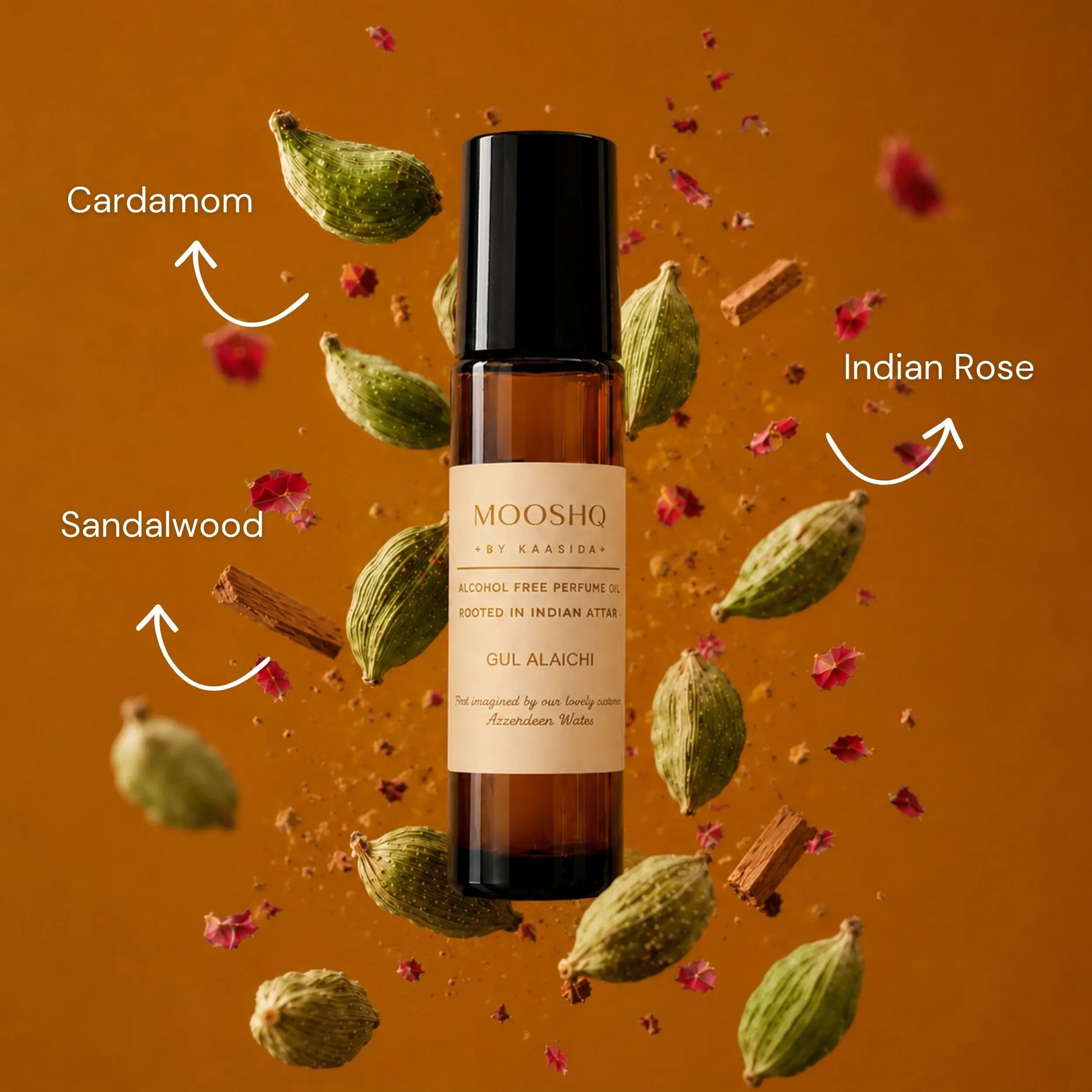 Mooshq perfume oil bottle with cardamom, sandalwood, and Indian rose elements on an orange background
