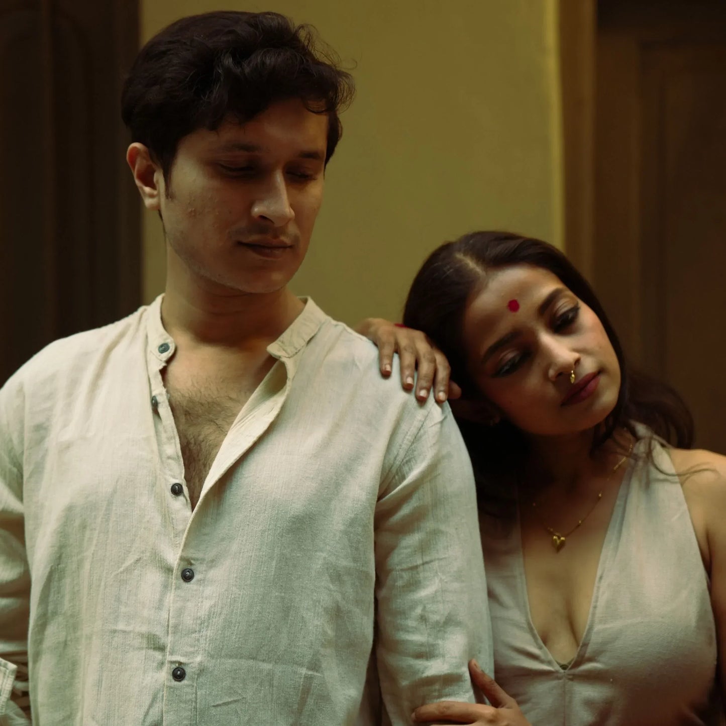 Man and woman standing close together with a warm, intimate atmosphere.