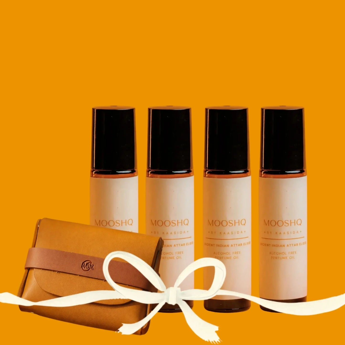Four bottles of MOOSHQ Perfume oil with a brown pouch on an orange background