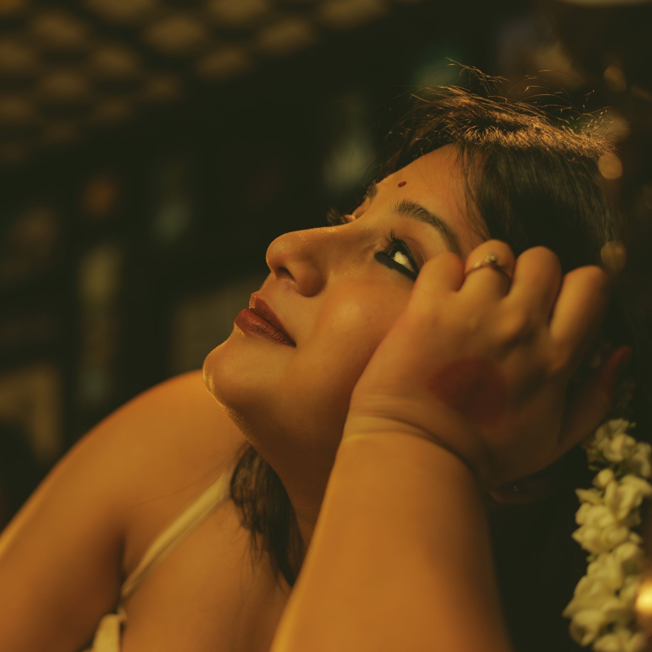 Woman adjusting her hair with a blurred background